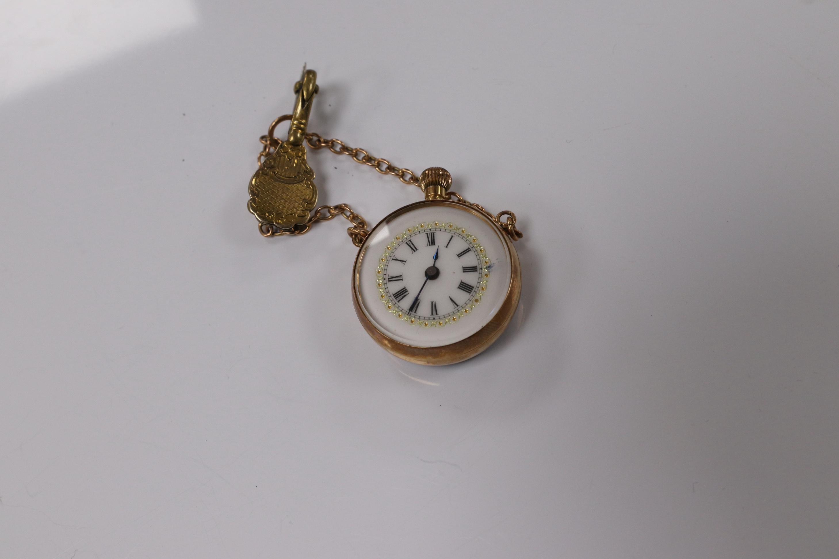 A lady's yellow metal mounted fob watch, with Roman dial and suspension chain with brooch, case diameter 26mm. Condition - fair